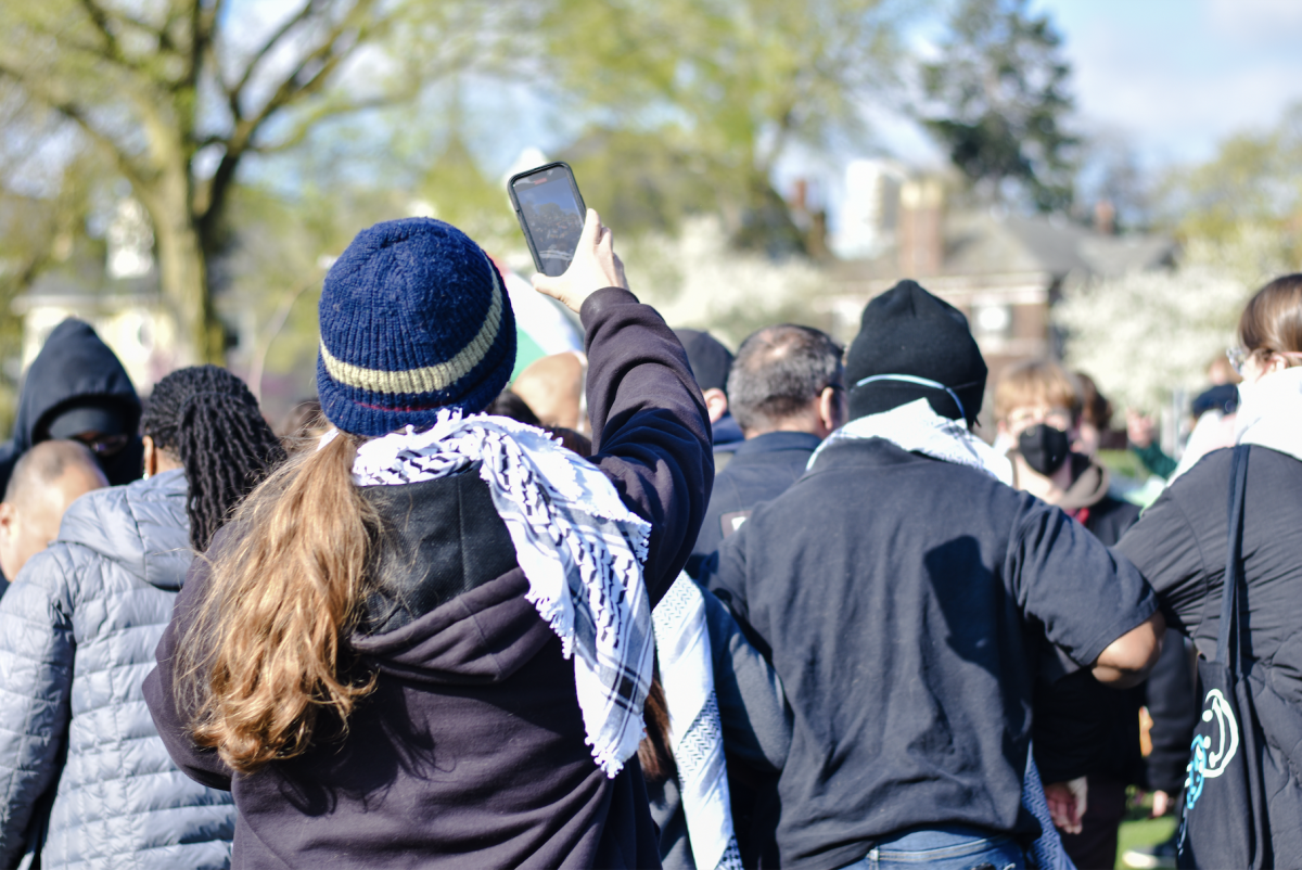 
A demonstrator records as Thrasher and others attempt to prevent University Police officers from dismantling the encampment. “You will not touch our students,” Thrasher repeatedly declared as officers attempted to break the human chain.